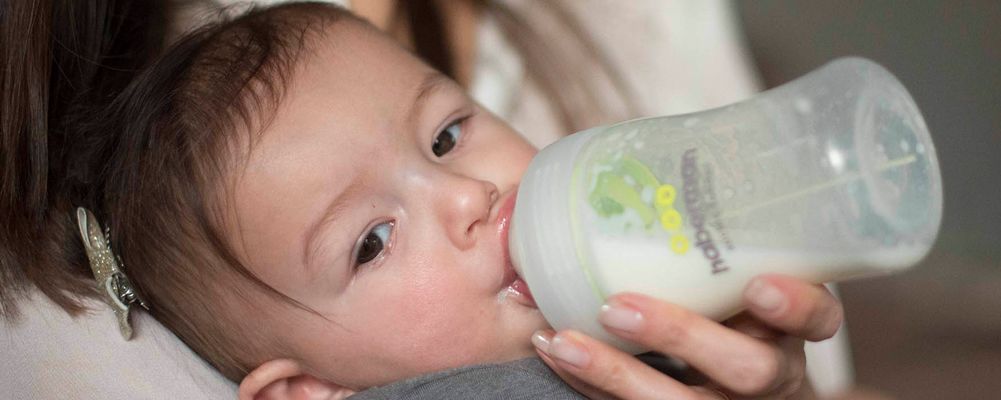 Baby with suckle feeder bottle